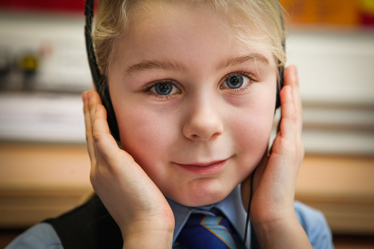 primary pupil with headphones